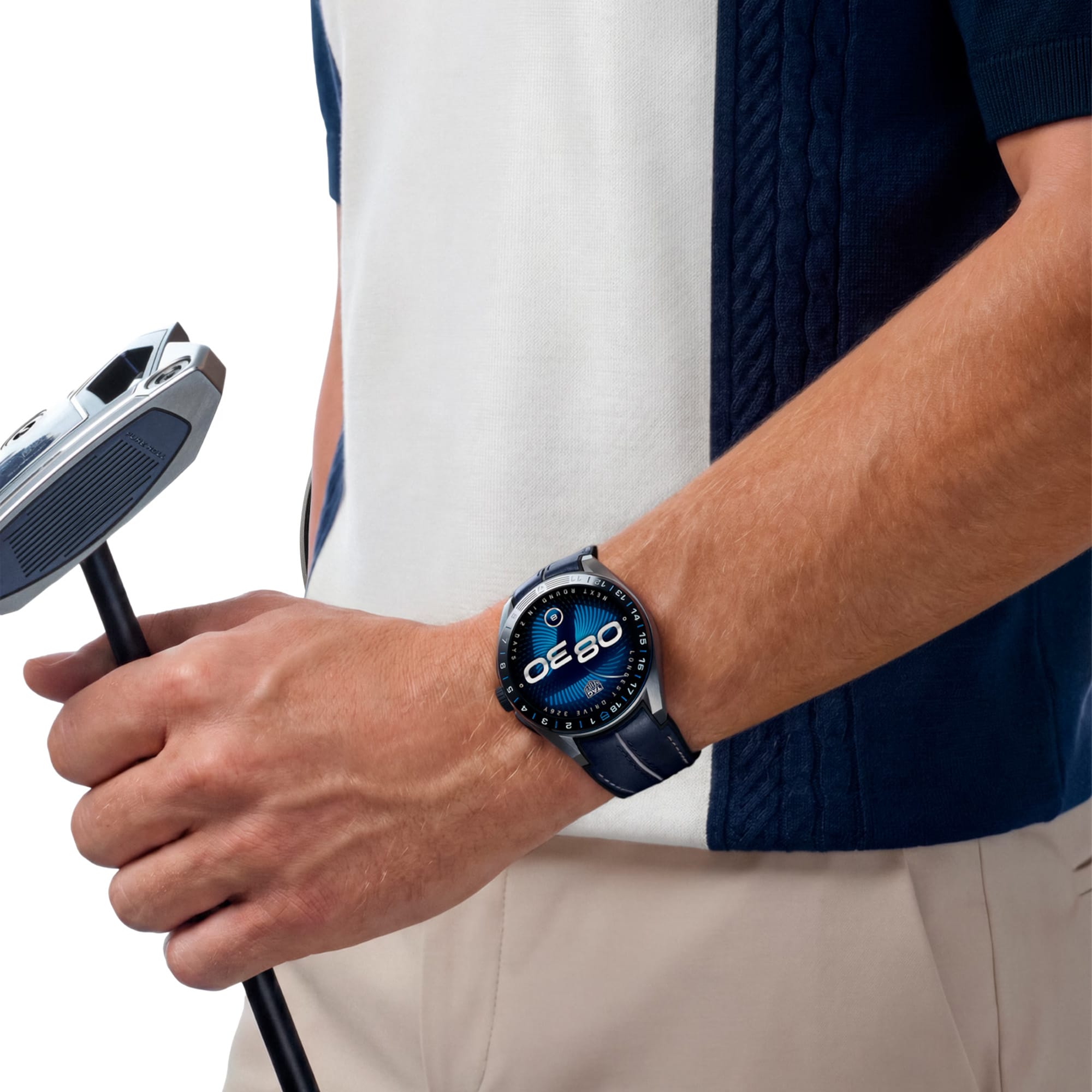 TAG Heuer Connected Calibre E5 x TaylorMade Edition SBT8A86.EB0421 shown worn on the wrist, illustrating the case proportions and perforated strap fit. The touchscreen display stands out against the sleeve in frame.