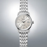 Close-up of King Seiko SJE089J silver dial showing applied indices, three hands, and date complication