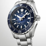 Three-quarter angle view of the Grand Seiko Evolution 9 SLGB023 men's titanium diver's watch, highlighting the blue gradient dial and faceted bezel. The screw case back and 300m water resistance rating support serious dive use.