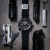 From this angle, the Seiko Prospex Solar Alarm Chronograph Men’s 47.80mm Diver’s Watch SNJ025P shows the black dial, rotating bezel and silver and black case together with the black silicone strap.