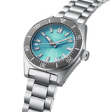 From this angle, the Seiko Prospex Limited Edition 'Save The Ocean' Automatic Men's 40mm Watch SPB545J shows the sunray teal dial's shimmer and grey bezel together with the stainless steel case and bracelet.