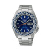 The Seiko 5 Sports Automatic Men’s 42.50mm Watch SRPK65K has a petrol blue dial with LumiBrite hands and markers and a day-date window. The 42.5mm steel case has a white-and-blue checkered bezel.