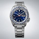 The Seiko 5 Sports Automatic Men’s 42.50mm Watch SRPK65K shows the dial’s baton markers, vintage-style hands and day-date window. The checkered bezel insert sits around the dial.
