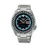 The Seiko 5 Sports SKX Series Men’s 42.50mm Watch SRPK67K has a black dial with LumiBrite hands and markers and a day-date window. The 42.5mm steel case has a black-and-silver checkered bezel.