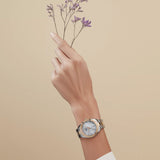 Tissot PR 100 Sport Chic 36mm T101.910.22.116.00 worn on wrist – white mother-of-pearl dial with diamond indexes, two-tone grey and rose gold PVD case and bracelet, elegant 36mm women's quartz watch shown on wrist