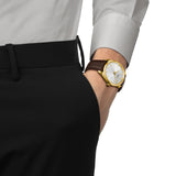 Tissot PR 100 40mm T150.410.36.391.00 worn on wrist – silver dial, yellow gold PVD bezel, brown leather strap, classic 40mm quartz watch shown on wrist