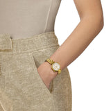Tissot Desir 28mm T152.010.33.118.00 worn on wrist – white mother-of-pearl dial with Roman numerals, yellow gold PVD case and bracelet, elegant 28mm women’s quartz watch shown on wrist