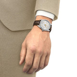 Tissot Visodate 39mm T157.407.16.031.00 front view – silver dial with gold indexes, stainless steel case, Dauphine hands, date window, brown crocodile-embossed leather strap - on wrist