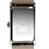 Timex watch case back in polished stainless steel, showing the engraved brand name and 'WATCHMAKERS EST. 1854' text, with a tan leather strap visible at the top and bottom on a white background.