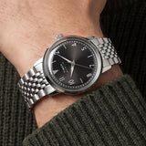 The Timex Marlin Quartz 34mm Watch TW6A04200 pairs its polished stainless steel case with a matching stainless steel bracelet for a refined, retro-inspired look on the wrist.