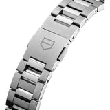 TAG Heuer Carrera Date WBN2313.BA001 shown worn on the wrist, illustrating the case proportions and steel bracelet fit. The pink dial stands out against the neutral tone of the sleeve in frame.