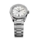TAG Heuer Carrera Date WBN231E.BA0001 photographed at an angle highlighting the mother-of-pearl dial's diamond indexes and diamond-set bezel. The steel bracelet curves away from the lugs, showing its link construction.