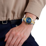 TAG Heuer Aquaracer Professional 200 Solargraph WBP1323.BB0004 shown worn on the wrist, illustrating the case proportions and two-tone bracelet fit. The blue dial stands out against the sleeve in frame.
