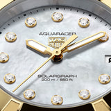 TAG Heuer Aquaracer Professional 200 Solargraph WBP1326.BB0004 captured in extreme close-up on the white mother-of-pearl dial, highlighting the dodecagonal diamond indexes and gold-plated hands. The date window at 3 o’clock sits against the pearlescent dial surface.