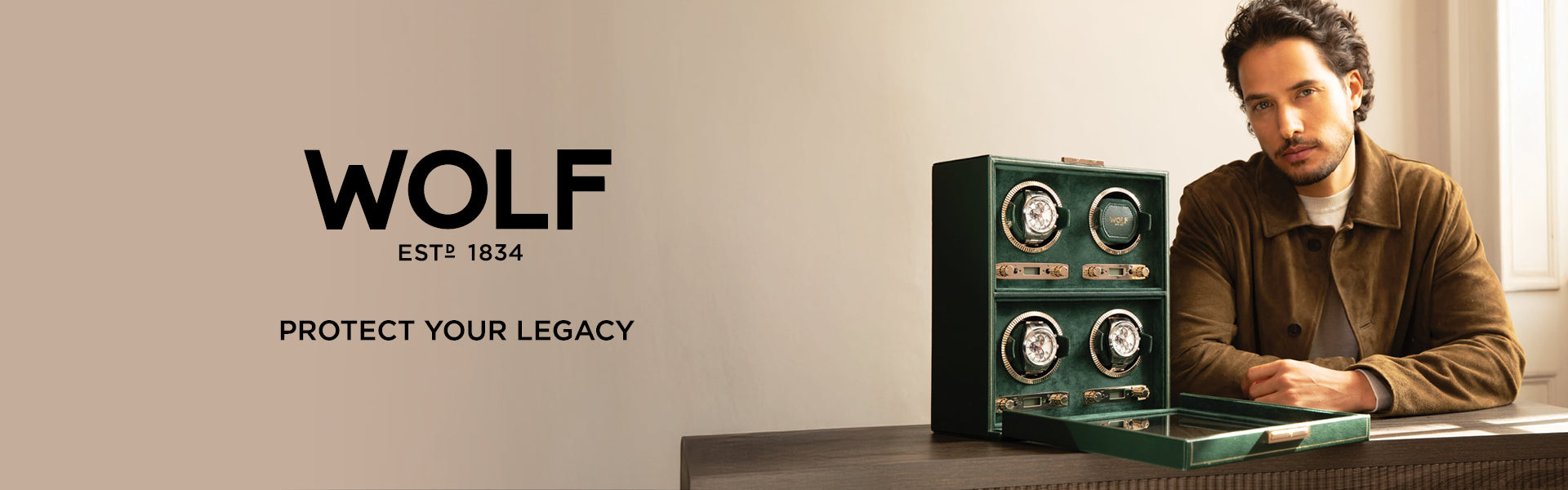 Wolf watch winder with a man sitting next to it on a table