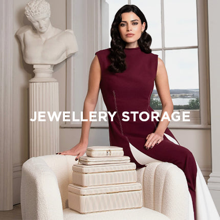 Woman sitting on a white stool with jewelry boxes, with text 'Jewellery Storage'.