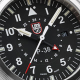 Close-up of the black dial on the Luminox Air Pilot P-38 Lightning Men's 42mm Quartz GMT Watch XA.9521, showing the Arabic numerals, baton markers, second time zone hand and date window. This P-38 Lightning pilot's watch features self-powered tritium tubes for constant visibility in the dark.