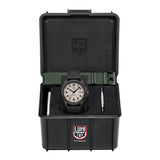 Front view of the Luminox Atacama Field Men's 43mm Quartz Watch XL.1971.SET with a black strap and a white dial, presented inside an open black hard case with a green woven strap and tools.