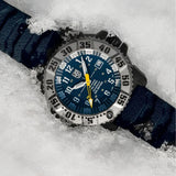 Luminox MIL-SPEC Inspired Men’s 46mm Quartz Watch XL.3355.2 shown in a rugged outdoor setting. This MIL-SPEC 3350 Series military watch features a blue dial, a titanium bezel and 300m water resistance.