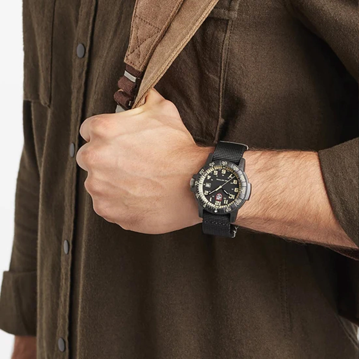 Luminox Leatherback SEA Turtle Giant Men's 44mm Quartz Watch XS.0333 worn on the wrist to show its size and fit. This Leatherback SEA Turtle Giant watch features a black dial with beige numerals, a rotating dive bezel and a lightweight black CARBONOX™ case on a black webbing strap.