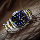 Luminox Sport Timer Men's 40mm Quartz Watch XS.0944 shown in a relaxed everyday setting. This Sport Timer 0940 Series watch features a blue sunray dial, gold-tone accents and 100m water resistance.