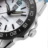 Close-up of the blue mother-of-pearl dial on the Luminox Pacific Diver Ripple Men's 39mm Quartz Watch XS.3124M, showing its natural shimmer, luminous hands and hour markers. This Pacific Diver Ripple dive watch features a date window and self-powered tritium tubes that glow constantly for up to 25 years.