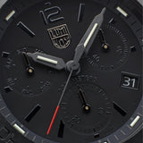 Close-up of the black blackout dial on the Luminox Pacific Diver Chronograph Men's 44mm Quartz Watch XS.3141.BO.1, showing the three chronograph sub-dials, luminous hands and markers, and date window. This Pacific Diver Chronograph features 14 self-powered tritium tubes for constant visibility in the dark.