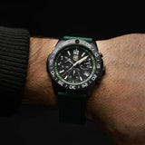 Luminox Pacific Diver Chronograph Men’s 44mm Quartz Watch XS.3147 worn on the wrist to show its size and fit. This Pacific Diver Chronograph features a forest green dial with three sub-dials, a black CARBONOX™ dive bezel and a black IP stainless steel case on a green rubber strap.