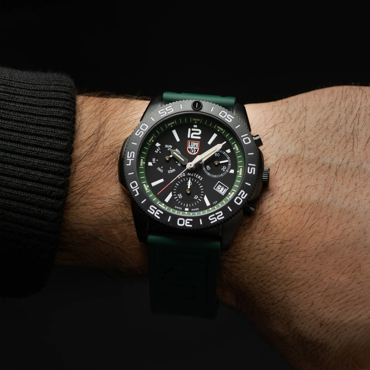 Luminox Pacific Diver Chronograph Men’s 44mm Quartz Watch XS.3147 worn on the wrist to show its size and fit. This Pacific Diver Chronograph features a forest green dial with three sub-dials, a black CARBONOX™ dive bezel and a black IP stainless steel case on a green rubber strap.