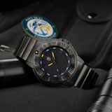 Luminox Navy SEAL Foundation Men’s 43mm Quartz Watch XS.3228.NSF shown in a rugged outdoor setting. This Navy SEAL Foundation 3220 Series dive watch features a black dial, a gunmetal steel bracelet and 200m water resistance.