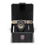 A Luminox Navy SEAL FoundationWatch with a black band and case, featuring a Tan face and additional strap in a box