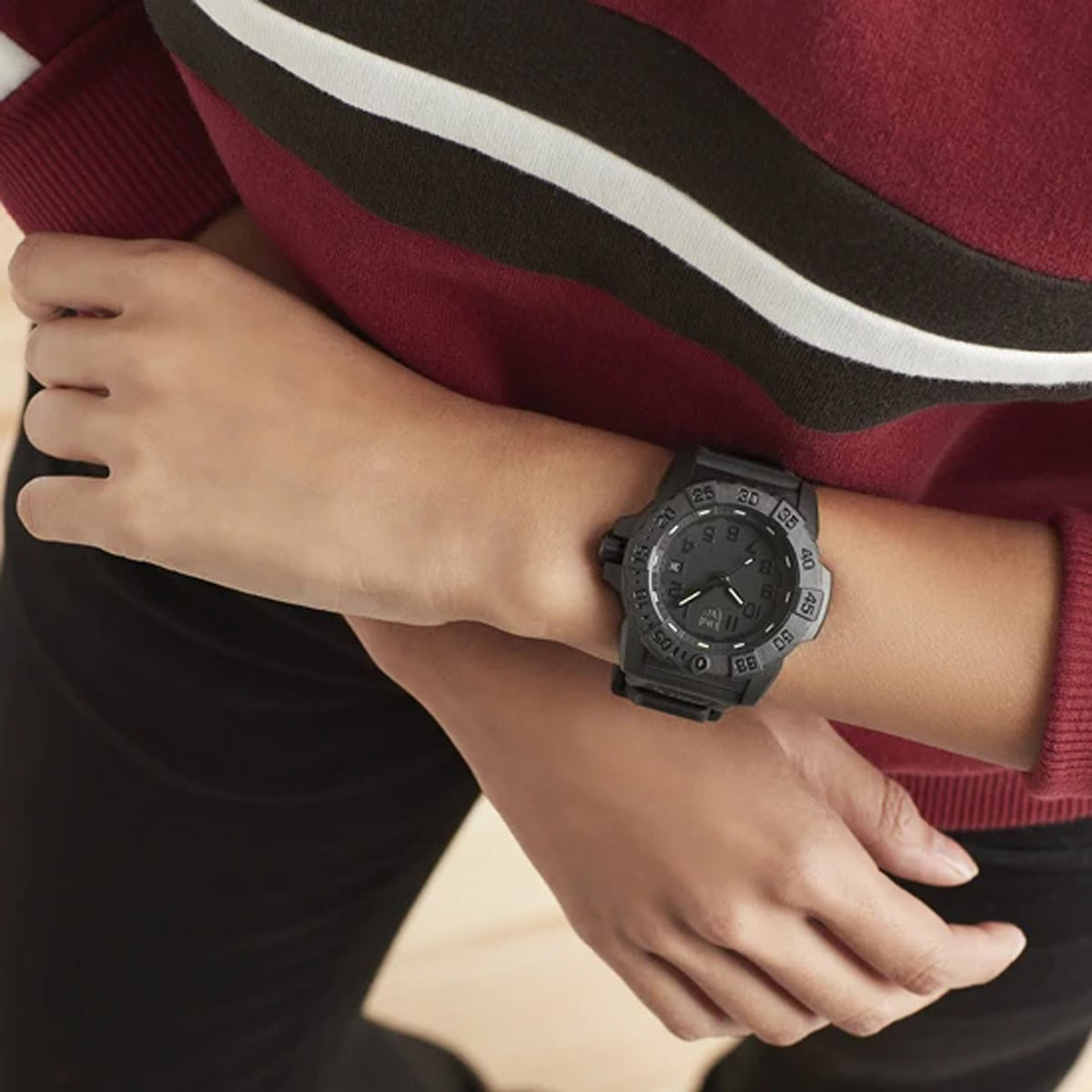 Luminox Navy SEAL Men's 45mm Quartz Watch XS.3501.BO.F worn on the wrist to show its size and fit. This Navy SEAL 3500 Series Blackout watch features a black-on-black dial, a black rotating dive bezel and a lightweight black CARBONOX™ case on a black strap.