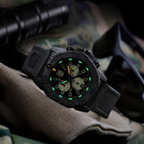 Luminox Navy SEAL Chronograph Men’s 45mm Quartz Watch XS.3587 shown in a rugged desert-inspired outdoor setting. This Navy SEAL Chronograph 3580 Series dive watch features a sand and black dial, a lightweight CARBONOX™ case and 200m water resistance.