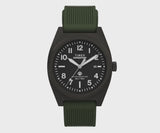 This angle highlights the date window and luminous dial markers against the brushed case. The green silicone strap complements the case's understated, rugged design.