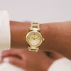 Video of - The Guess GW0869L4 is shown face-on, highlighting its 30mm gold-tone case and champagne sunray dial. Crystal bezel touches add a subtle sparkle to the design.