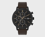 The Timex Chicago Chronograph TW2W13200 features a textured black dial with gold-tone hands and accents. Three sub-dials display 60-second, 30-minute, and 24-hour chronograph functions.