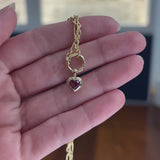 Video of a Wallace Bishop Charm Holder Chain in 9ct Yellow Gold, 500mm (approximately 19.7 inches) in length, with the Heart Rhodolite Garnet Double Bezel Pendant in 9ct Yellow Gold, reference 93PDHTRH1Y, added to it. The pendant features a 5mm heart cut rhodolite garnet in a polished gold double bezel.