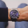 The Guess Walker GW0900G4 is shown face-on, highlighting its 44mm silver-tone case and rich blue sunray dial. The tachymeter scale and multi-function layout add depth and detail.