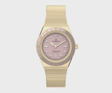 This angle highlights the luminant markers and the stationary top ring. The gold-tone case catches the light across its compact, polished silhouette.